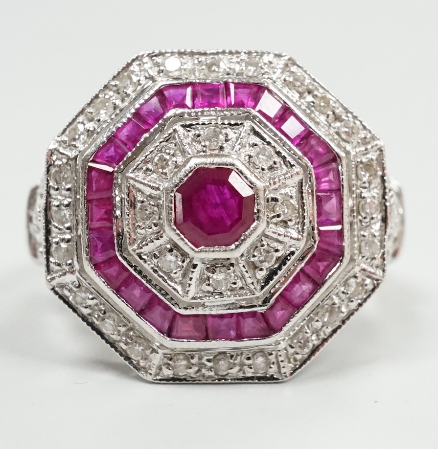 A mid to late 20th century 18ct white gold, ruby and diamond set octagonal cluster target ring, size N/O, gross weight 7.1 grams.